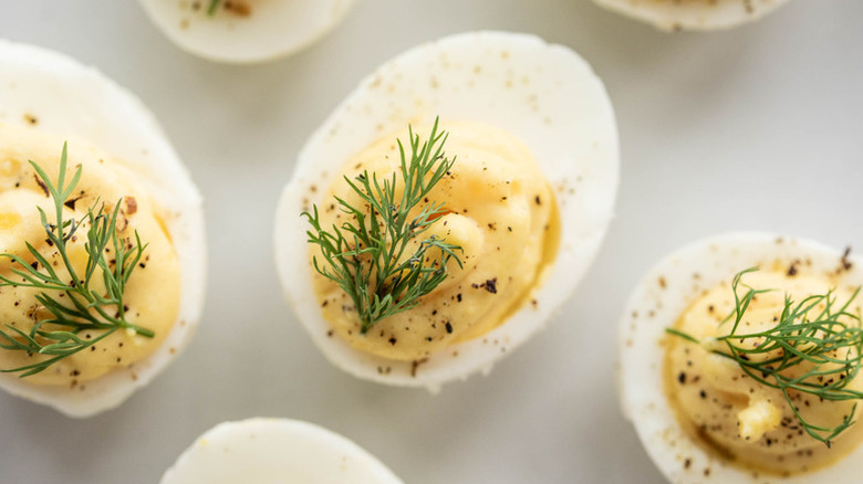 Deviled eggs topped with sprigs of fresh dill