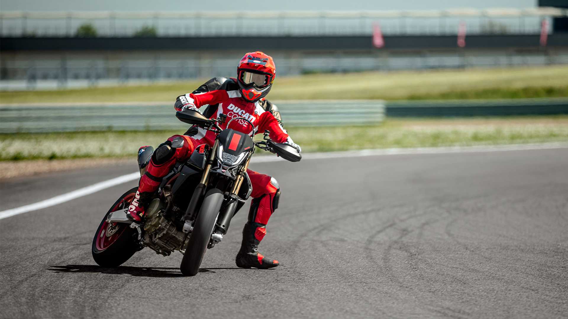 An action shot of a Ducati Hypermotard 698 sliding into a corner