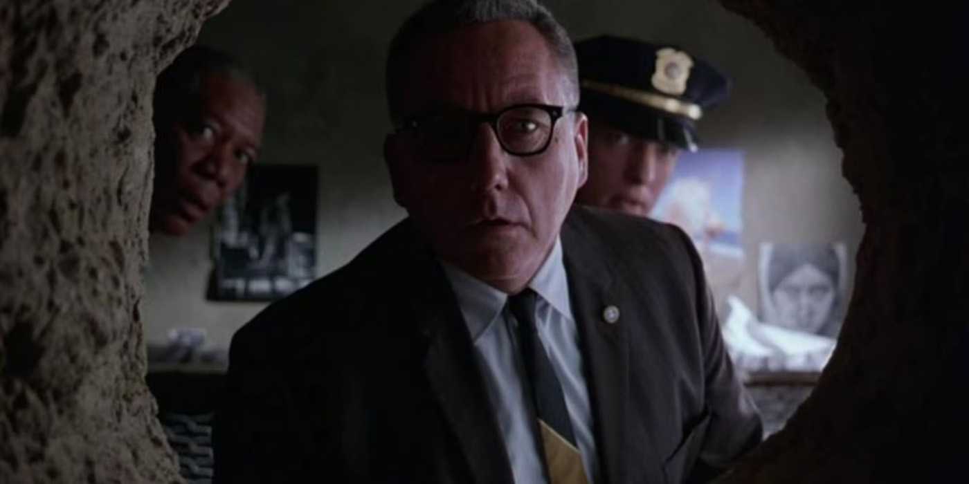 Warden Norton looking through Andy's escape tunnel in Shawshank Redemption