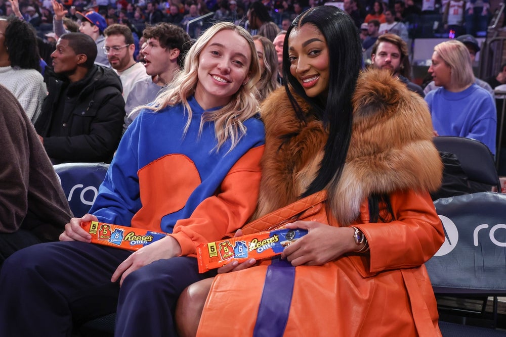 Dec 7, 2025; New York, New York, USA; WNBA players Paige Bueckers (l) and Angel Reese (r) sit courtside during the game between the Orlando Magic and the New York Knicks at Madison Square Garden. Mandatory Credit: Wendell Cruz-Imagn Images