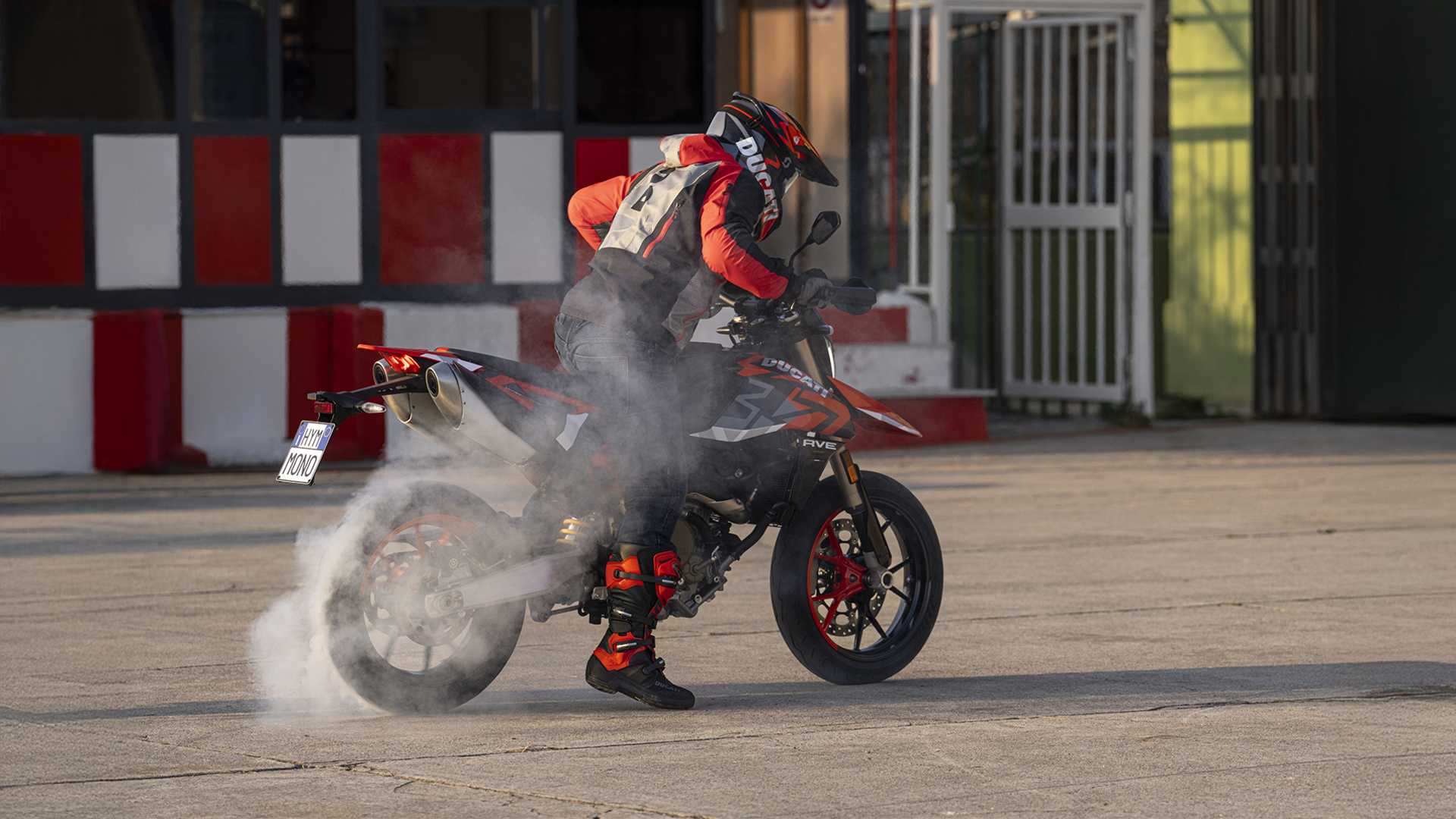 An action shot of a Ducati Hypermotard 698 doing a burnout