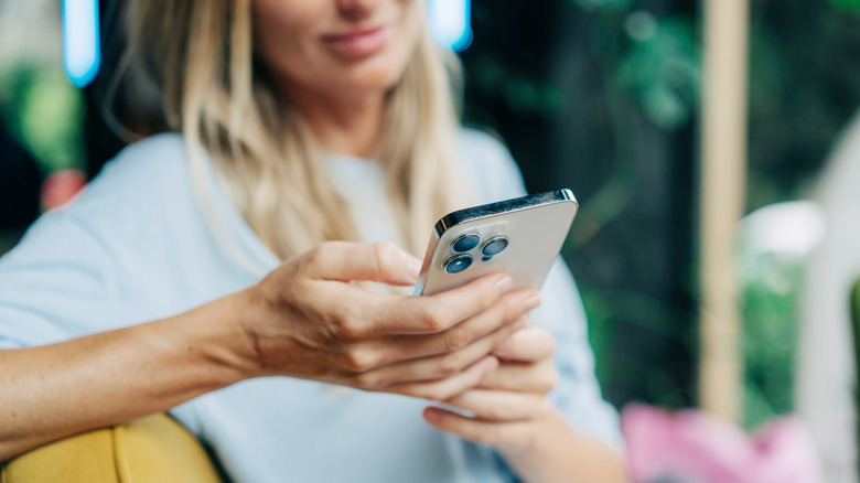 Woman scrolling through iPhone