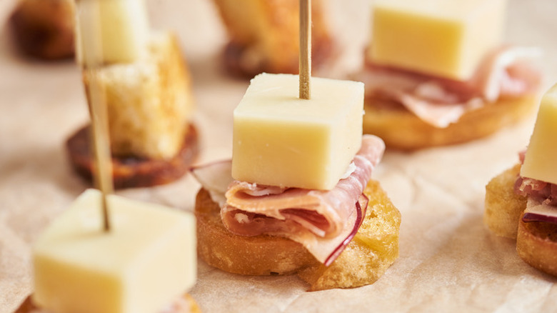 Close up of ham, cheese, and sourdough charcuterie skewers