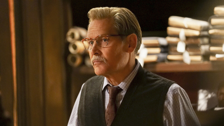 James Remar as Peter Gambi standing in front of a waall of fabric in Black Lightning
