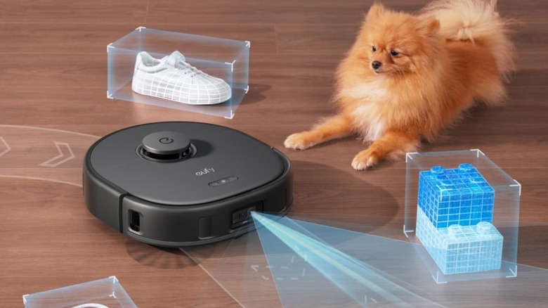 A Eufy robot vacuum cleaning the floor with a pet and other obstructions on the floor