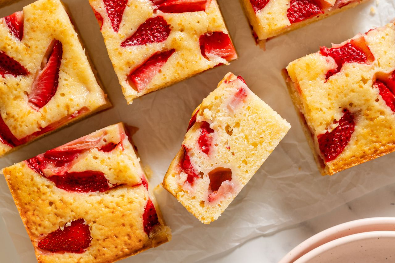 Slices of strawberry cake arranged on parchment paper