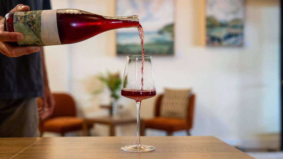 ídola wine co. co-owner Ryker Wall pours a glass of rosé at the Creamery in San Luis Obispo. The tasting room opened in June, shown here on July 14, 2026. The company specializes in producing and selling organic, all-natural wines.
