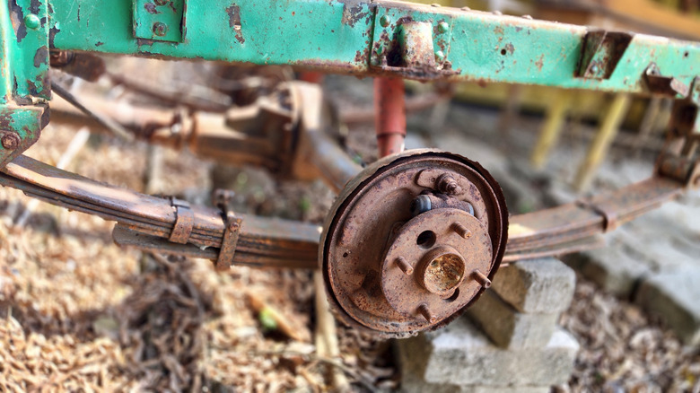 Close-up of brake drum with severe rust, disassembled with no shoes