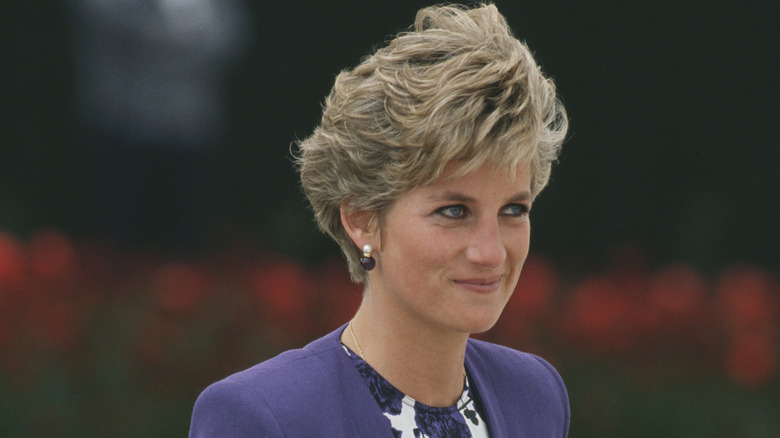 Princess Diana wears a layered bob haircut and blue blazer