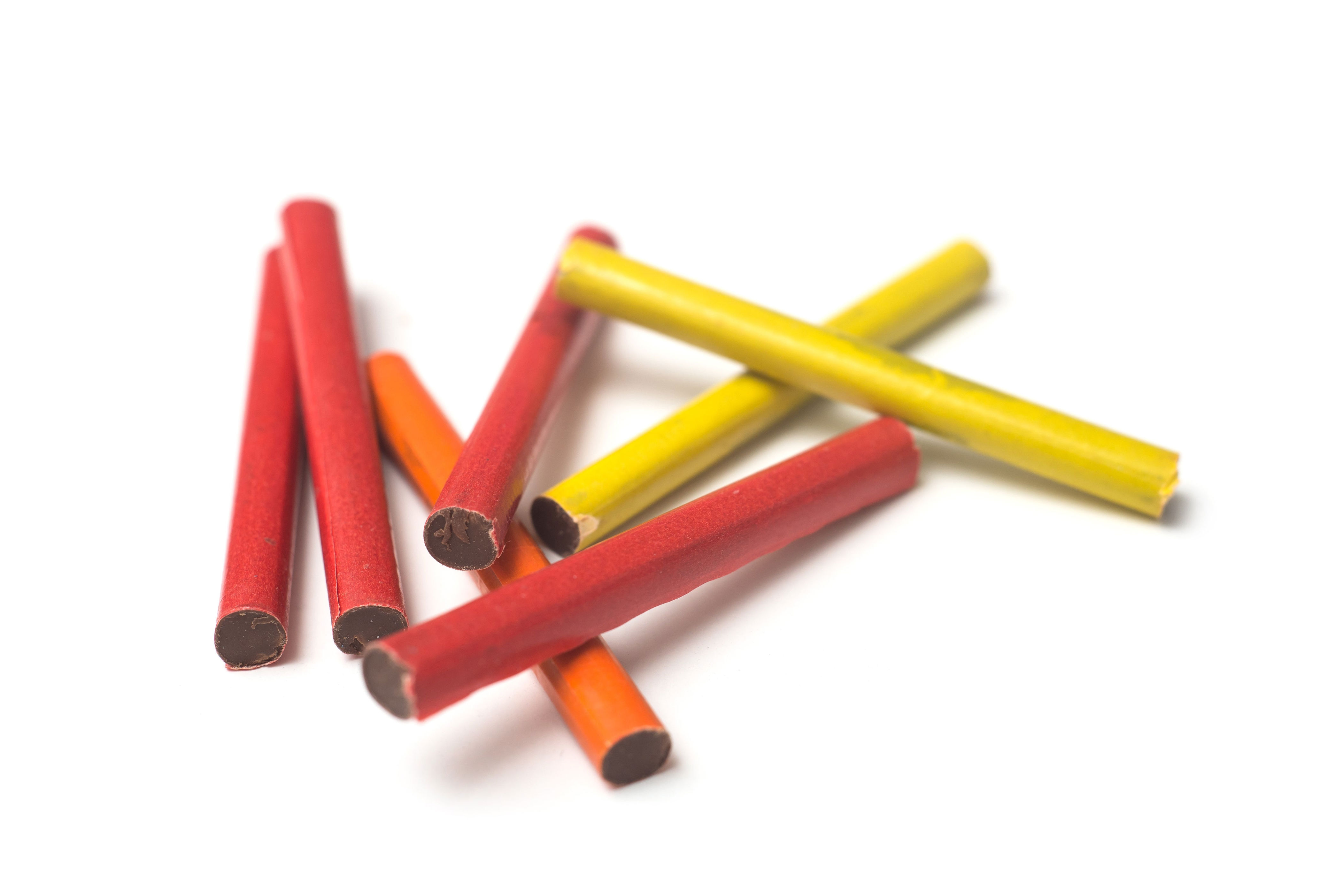 Colorful chocolate-filled candy sticks scattered on a white surface