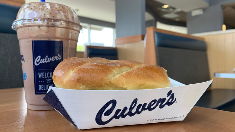 Culver's burger in a paper tray in front of chocolate shake