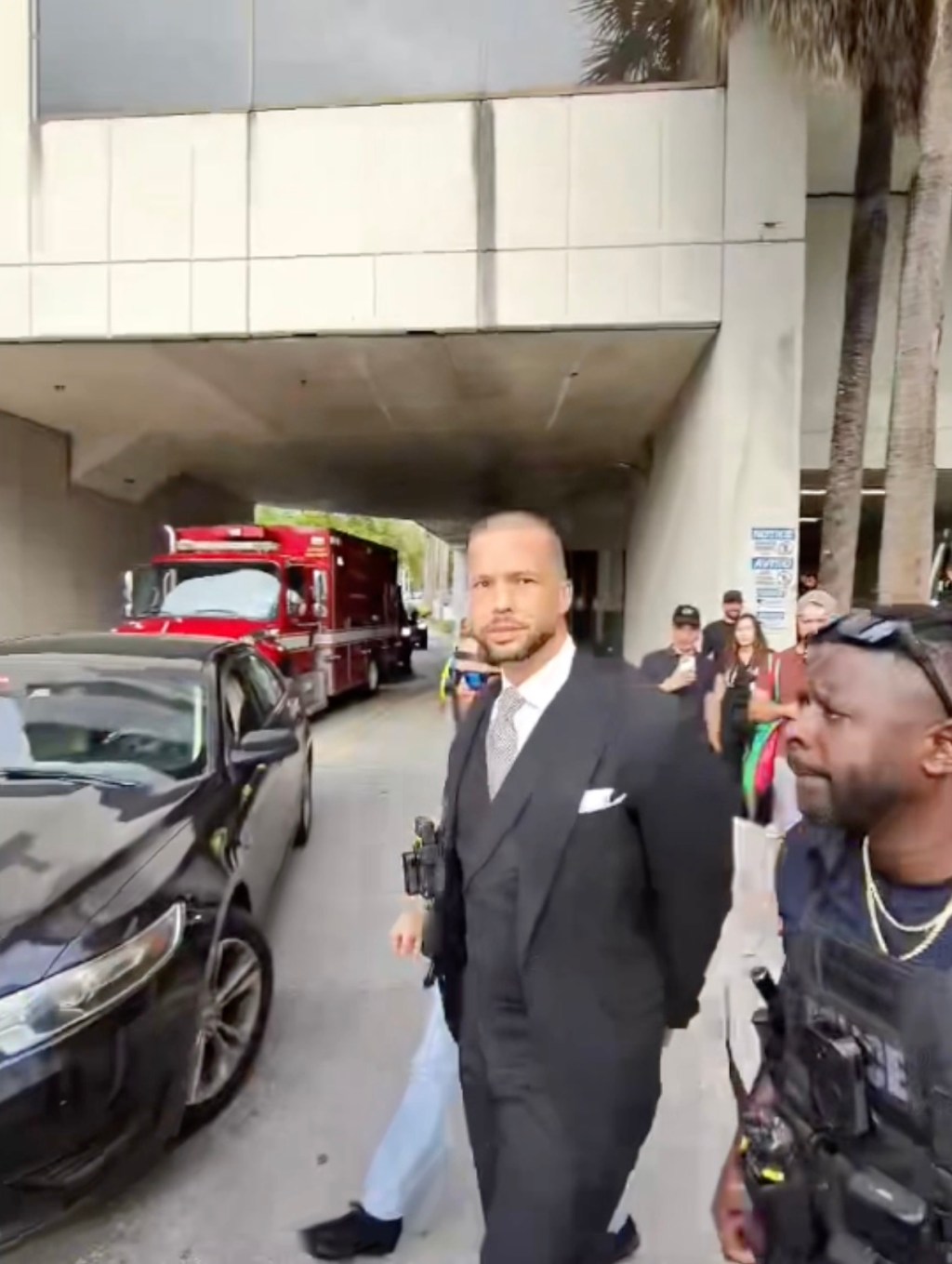 Andrew Tate arrest video shows moment he tried to give phone to bodyguard as he’s cuffed by US Marshals