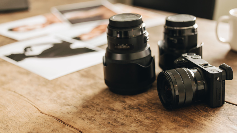 Mirrorless camera placed next to interchangeable lenses.