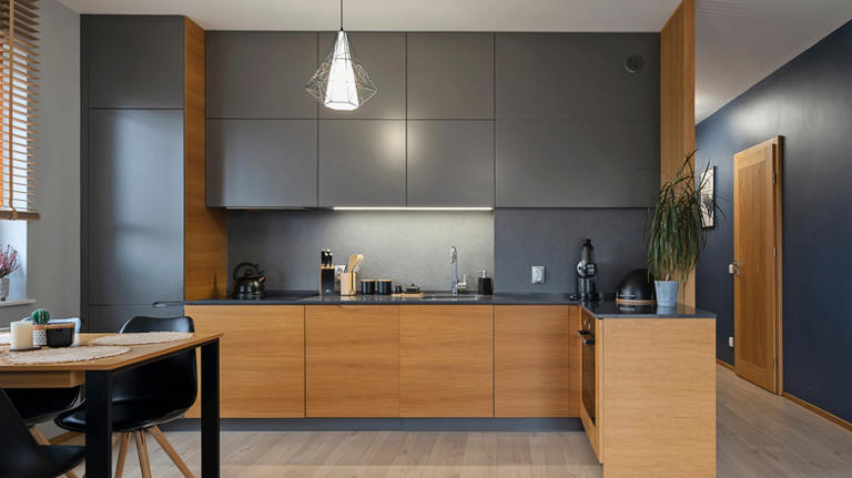 She gives orange oak cabinets a moody transformation with a clever DIY
