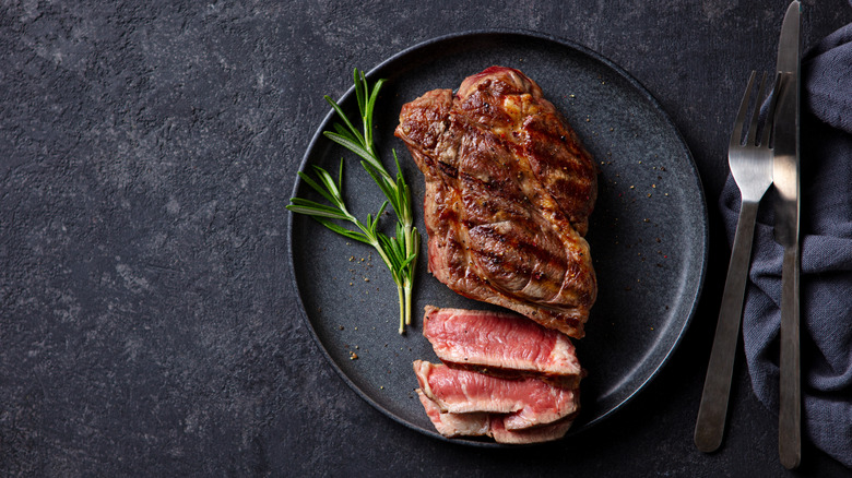 Sliced rare steak with rosemary