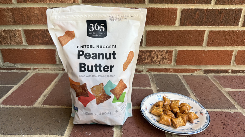 Bag of 365 peanut butter-filled pretzels on brick surface, with some displayed on adjacent plate