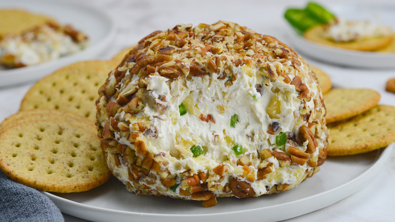 Jalapeño pineapple cheese ball on plate with crackers