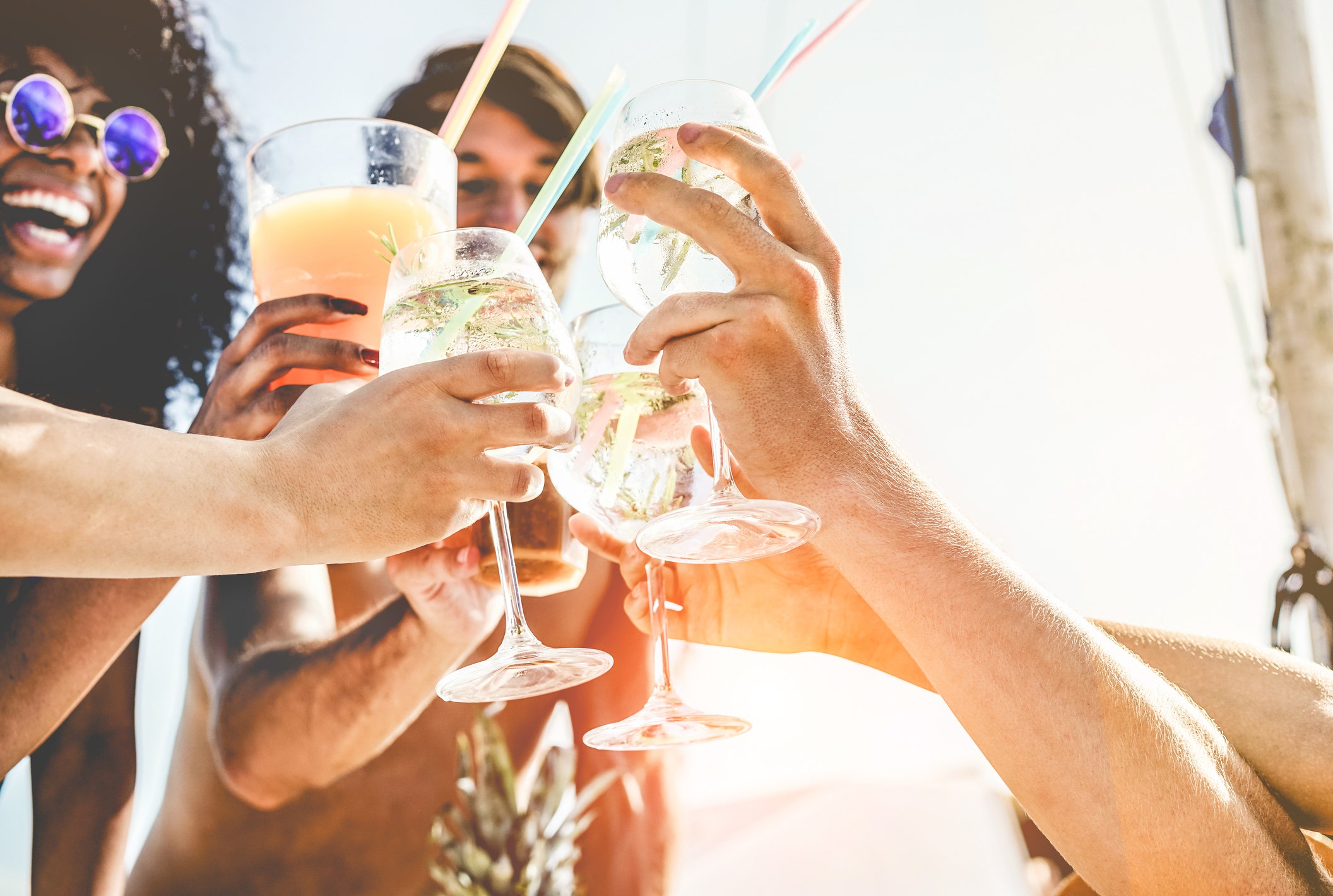 People clinking glasses and having drinks.