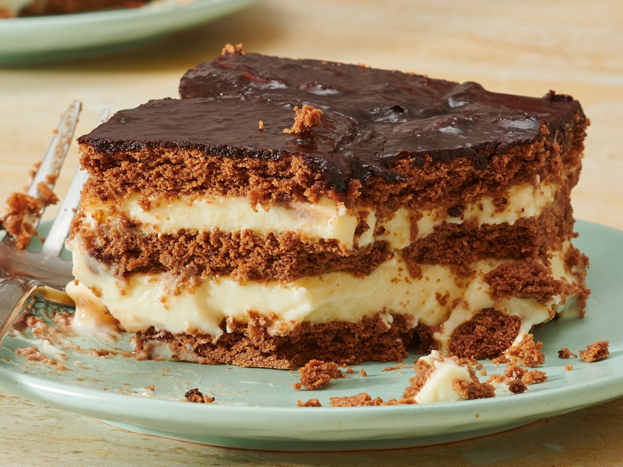 Layered dessert with chocolate topping served on a plate