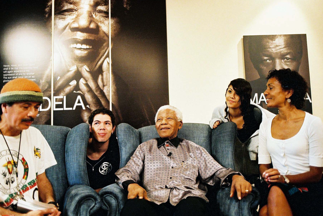 The author with her family, including then-husband Carlos Santana (left), visiting Nelson Mandela (center) in 2006.
