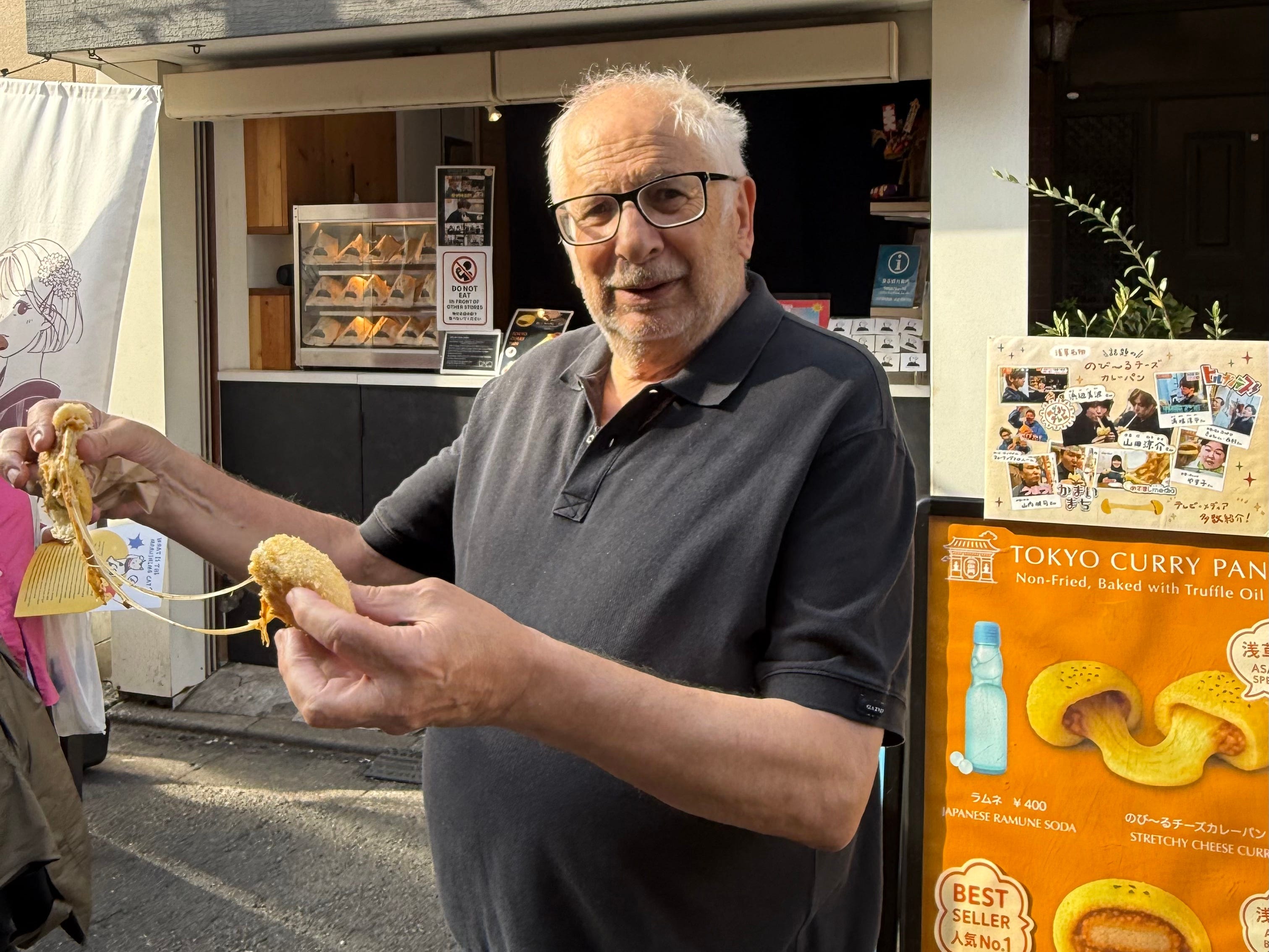 Man pulling apart a curry bun