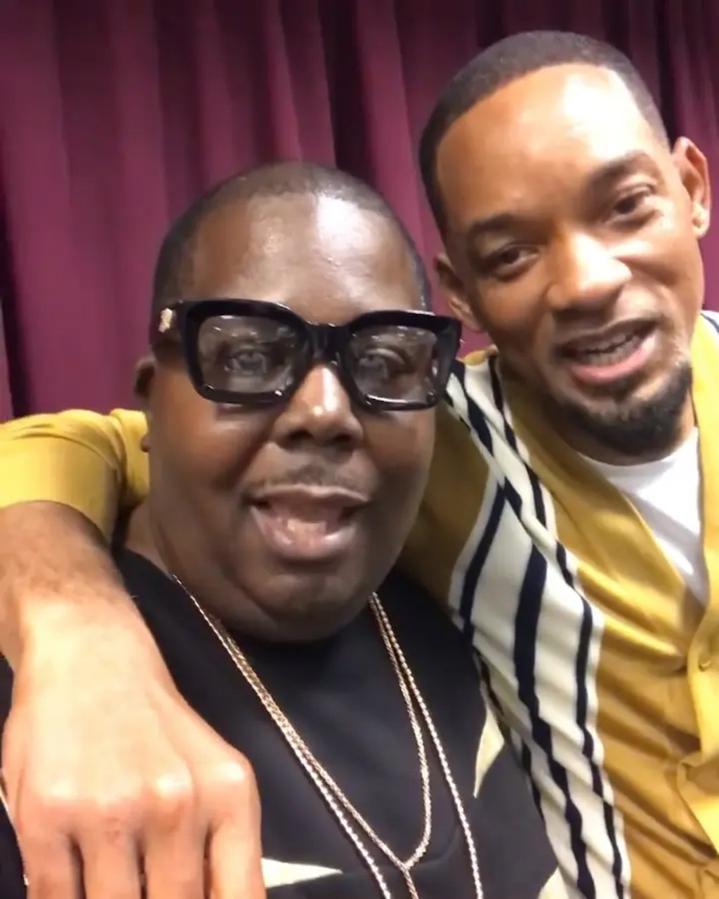 Will Smith smiling with his arm around his former associate.