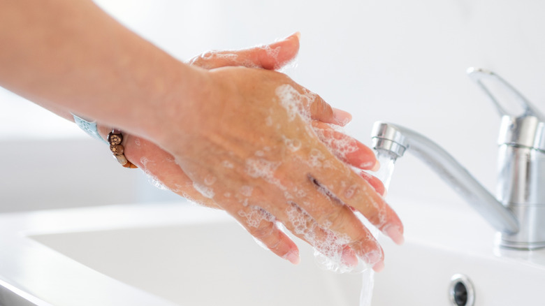 washing her hands in public restroom
