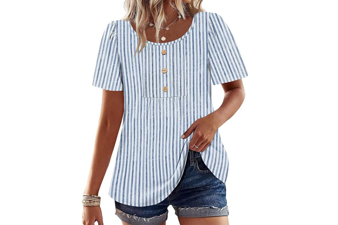 Person wearing a striped blouse with buttons and denim shorts with bracelets on one wrist