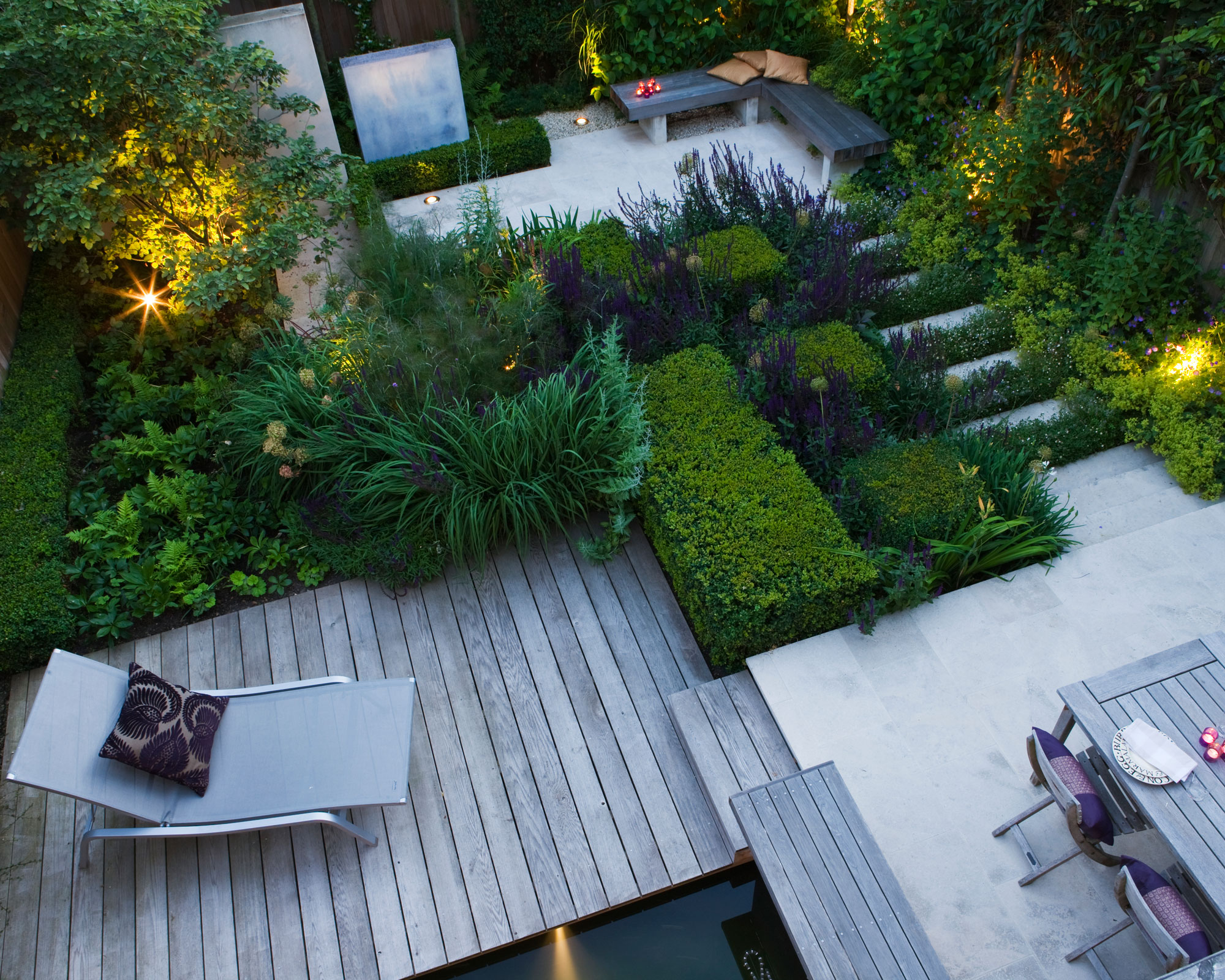 modern urban split level garden design with raised deck, garden steps, garden furniture, smart planting and garden lighting