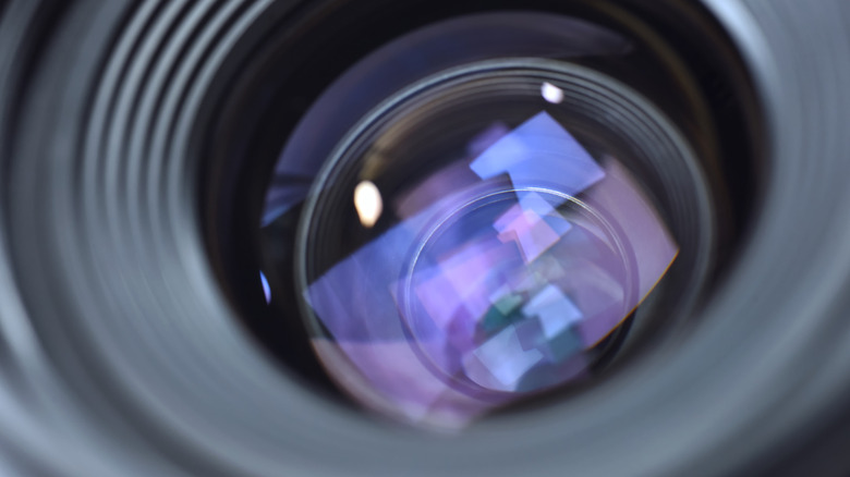 Close-up view through the front element of a camera lens.