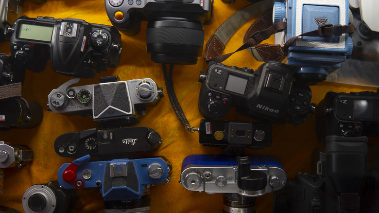Mirrorless and DSLR cameras displayed side by side on a table.