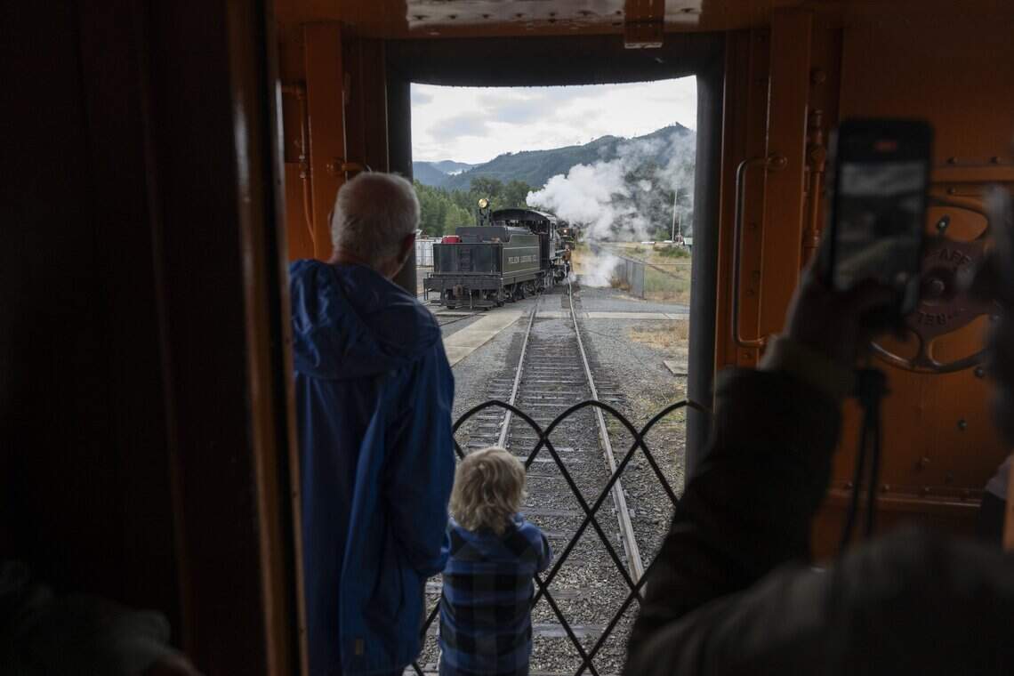 Passengers watch as the engine of the Mt. Rainier Scenic Railroad is moved from front to back to begin its return journey to Elbe on Thursday, July 16, 2026, in Mineral.