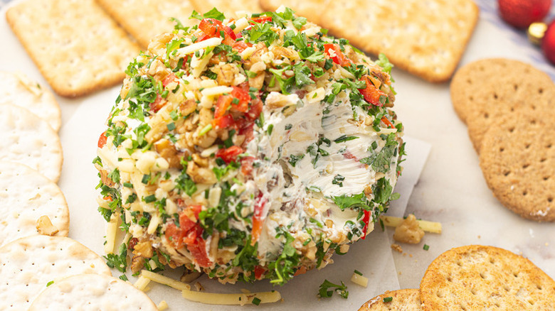 Red and white Christmas cheese ball served with crackers