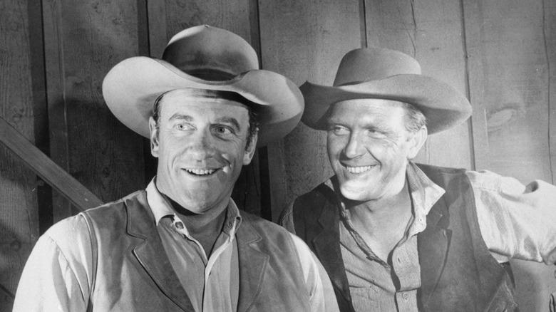 Actors James Arness on the left and Robert Lansing on the right, in costume on the set of the TV show 