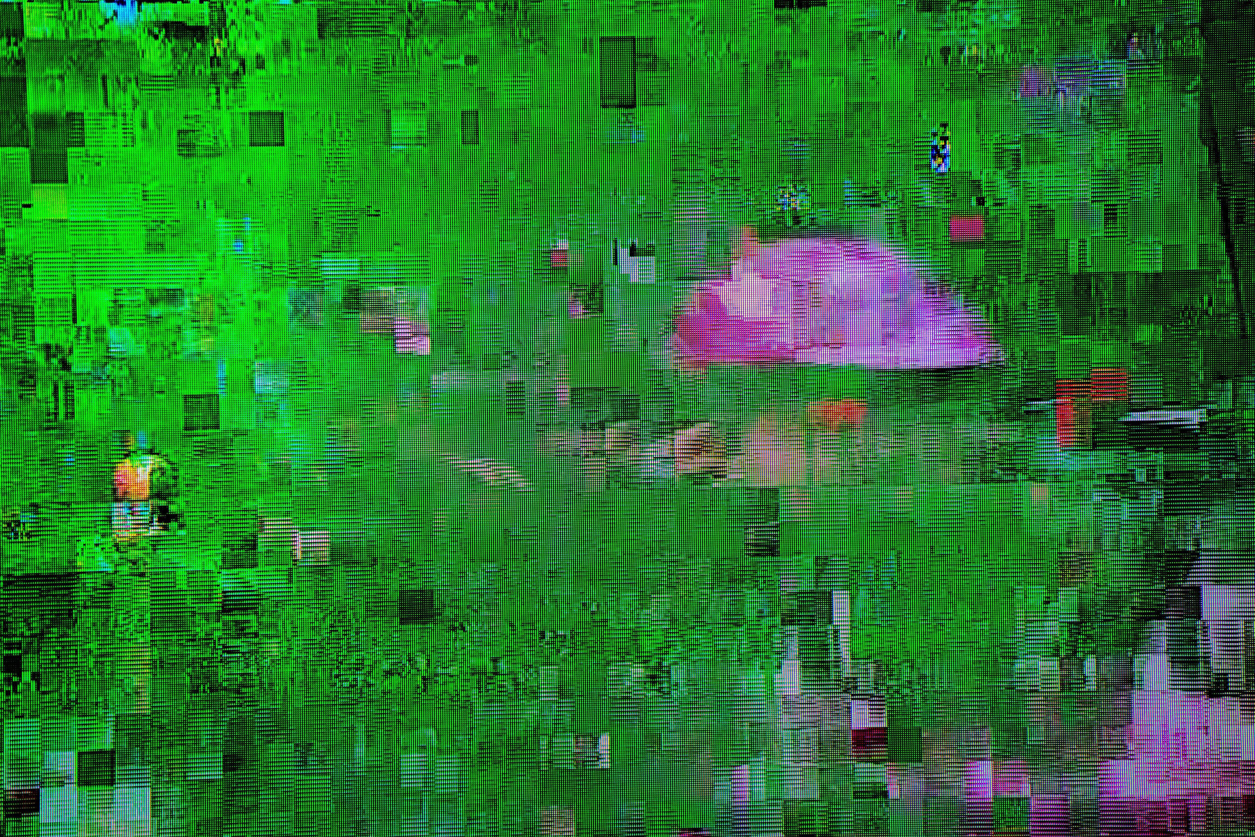 A pixelated, glitchy image with distorted shapes and colors, making it difficult to discern clear objects or subjects