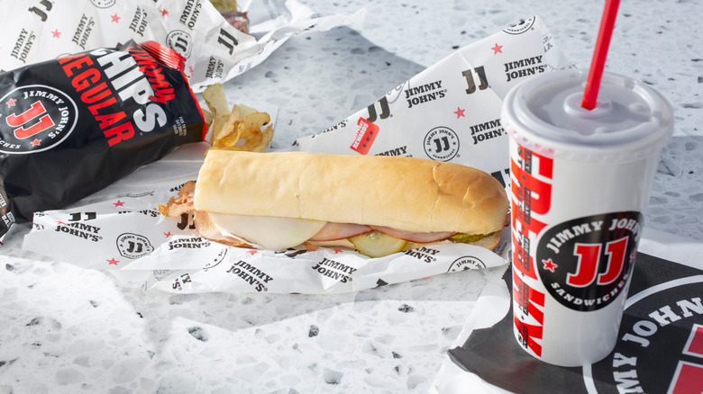 Jimmy John's combo meal with open potato chips, sandwich and drink on a counter
