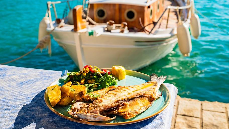 Grilled fish next to boat in Greek waters