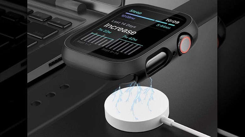 Black watch cases installed on a watch, placed on top of its charger.