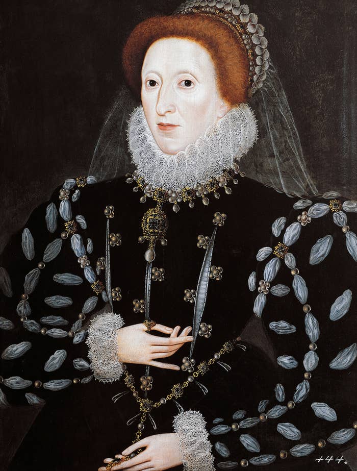 A historical portrait of Queen Elizabeth I in ornate, dark attire with lace details and a high collar, wearing a decorative headpiece