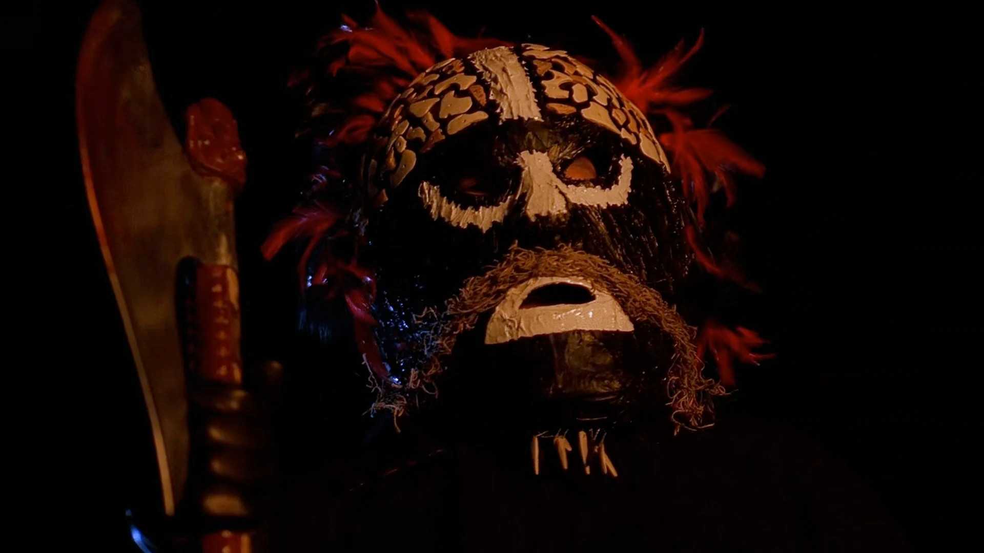 A man in a tribal mask with an axe in X-Files Our Town