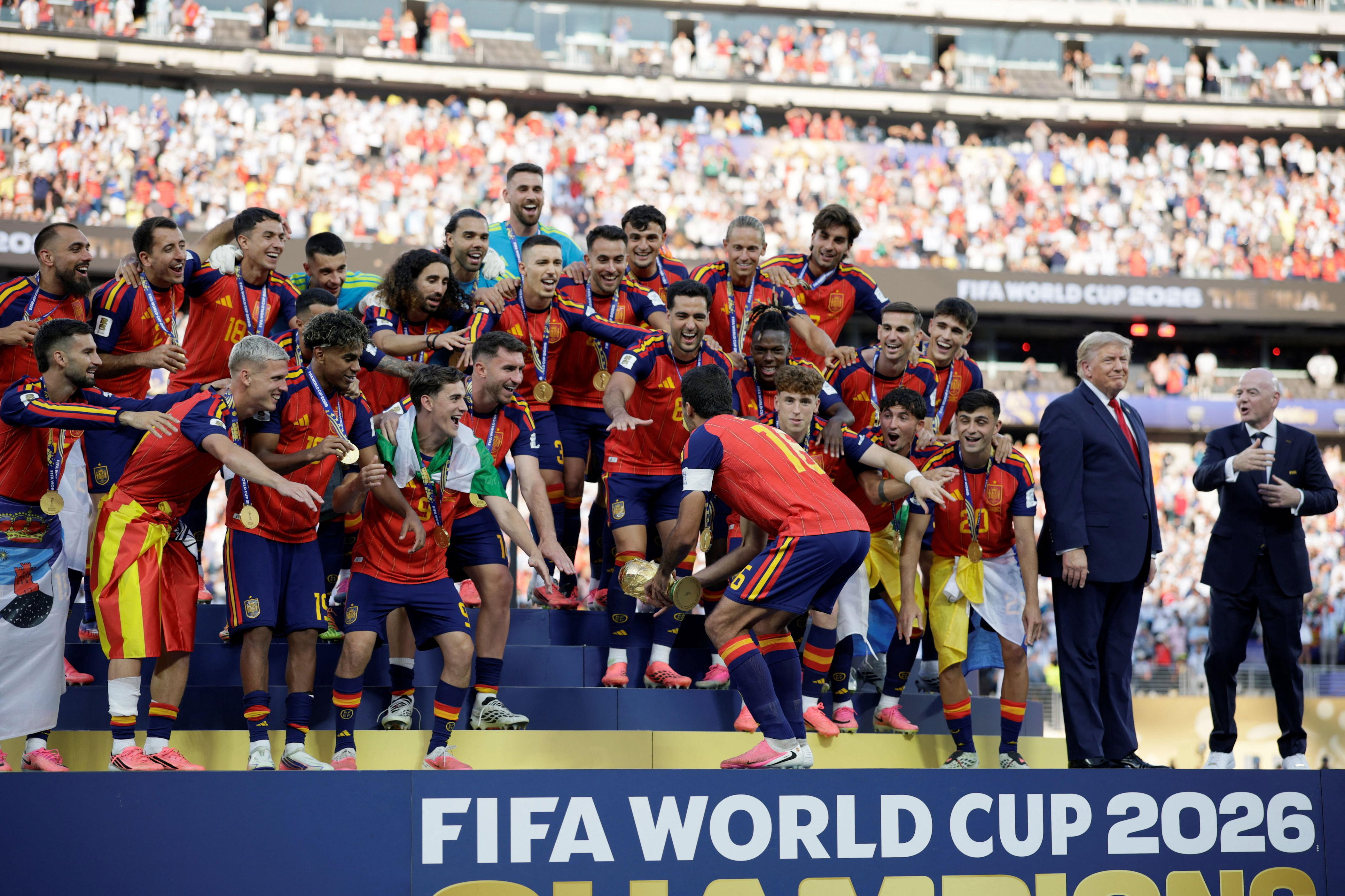 U.S. President Donald Trump refuses to leave the podium as Spain celebrate their World Cup win. / Evan Vucci / REUTERS