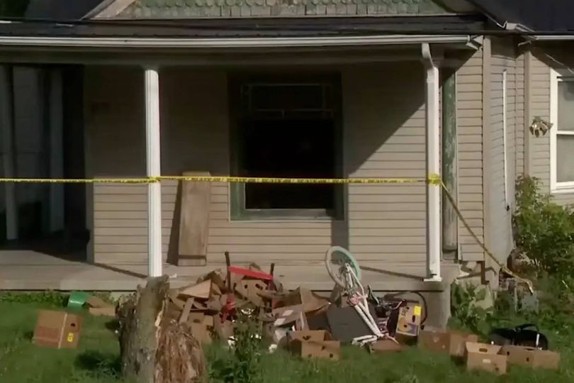 Police tape surrounds the home where authorities say they removed 16 children and arrested four adults in Hamden, Ohio