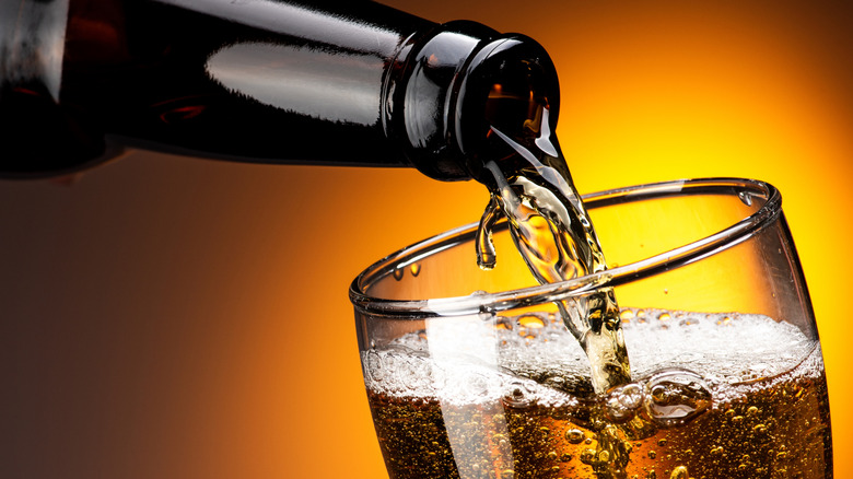 Beer being poured from a bottle into a glass