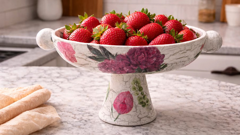 DIY tray made from an old pan holding fruit and sitting on a countertop