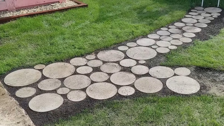 A walkway made with round concrete paveers