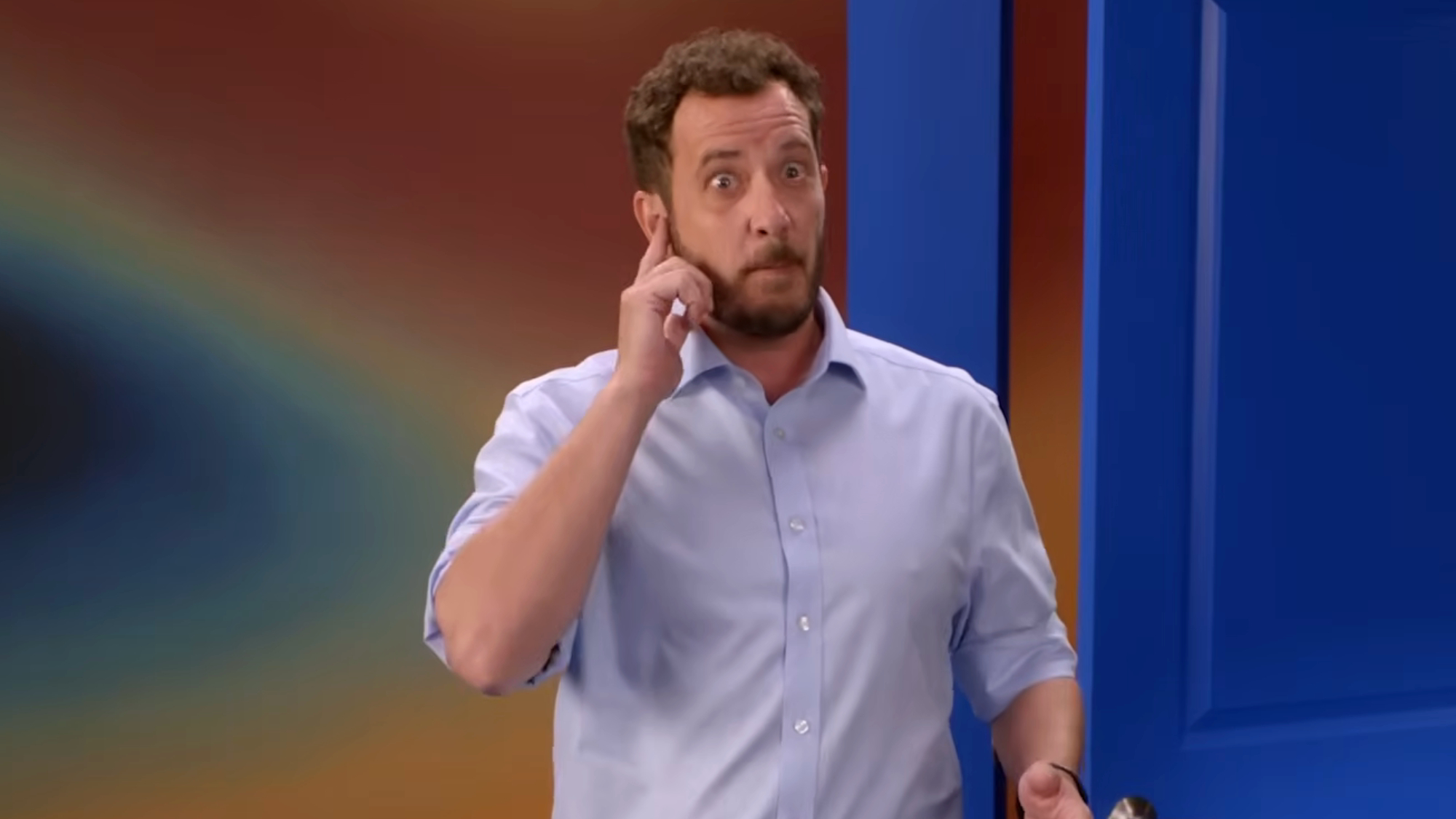 Rick Devens pretends to answer a phone call on Big Brother.