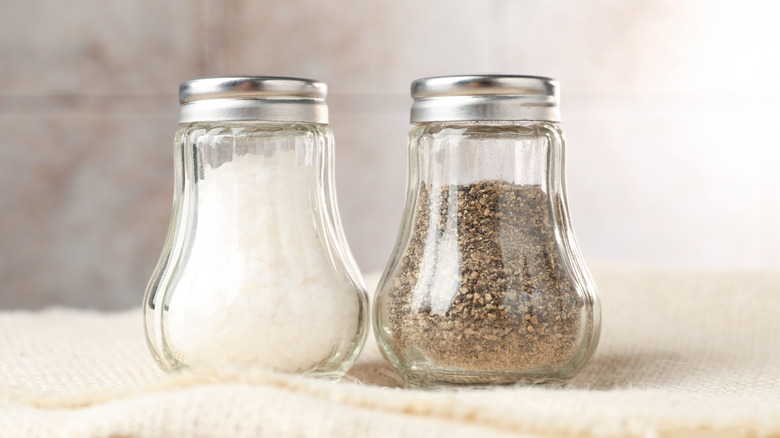 Salt and pepper shakers on table, closeup