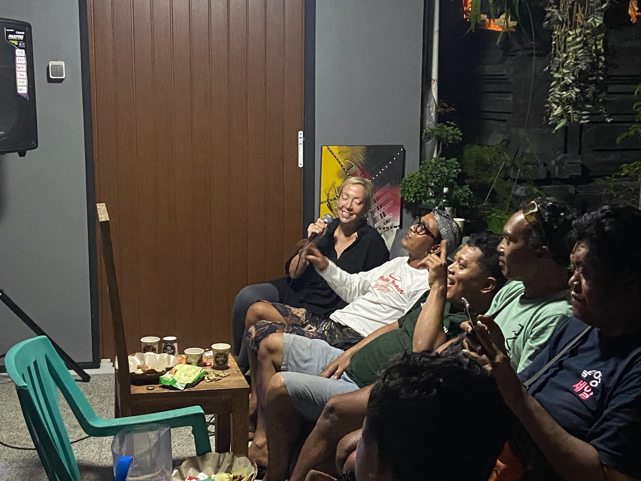 A group of people singing karaoke in Bali.