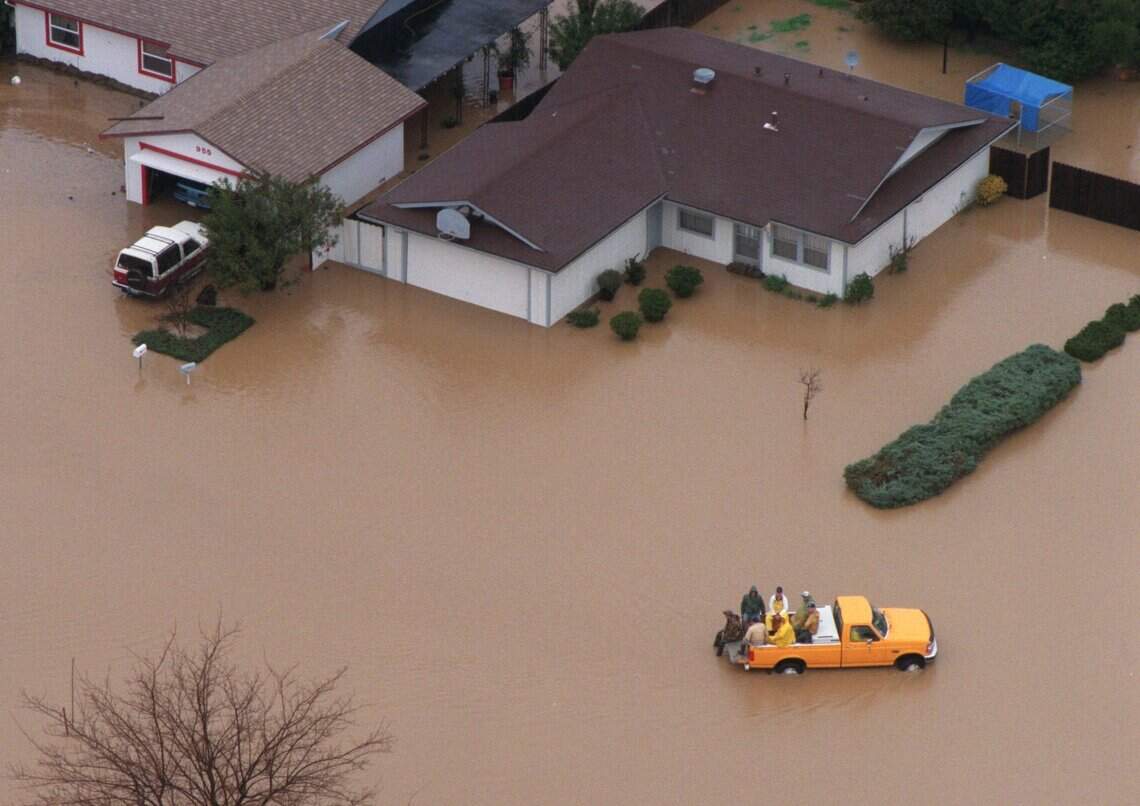 A truck drives through a neighborhood in Willows in February 1998 after days of rain flooded the area.