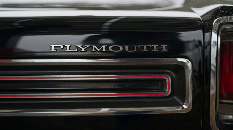 Close-up of Plymouth badge on the rear of a black Plymouth GTX